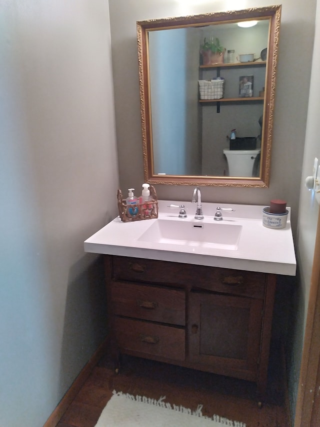 bathroom featuring toilet and vanity