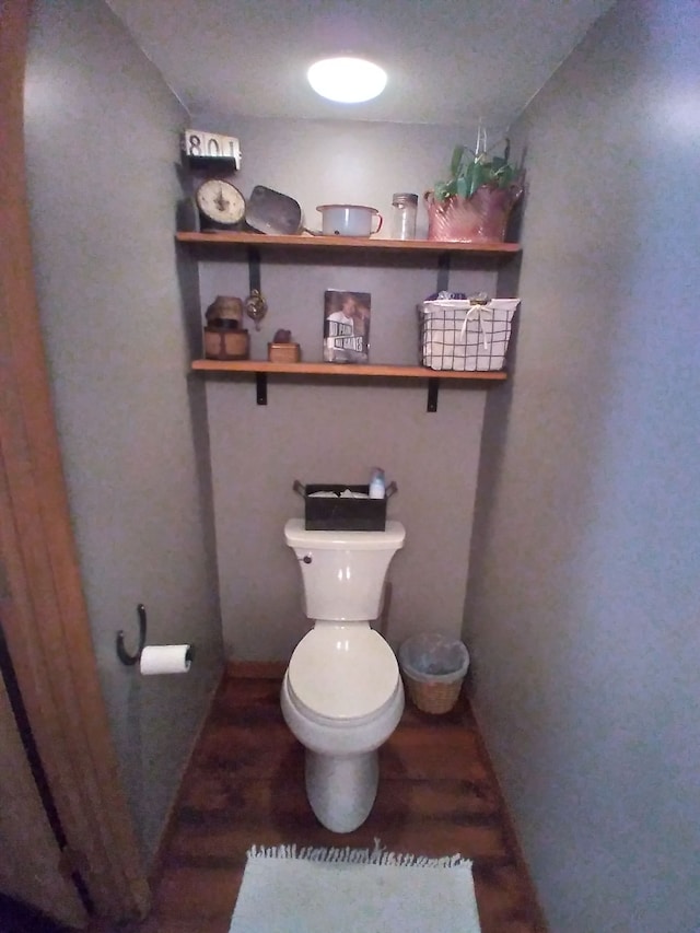 bathroom with toilet, a textured ceiling, and hardwood / wood-style flooring