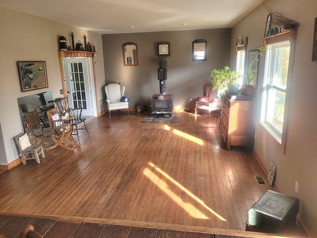 living room featuring a wood stove and hardwood / wood-style flooring