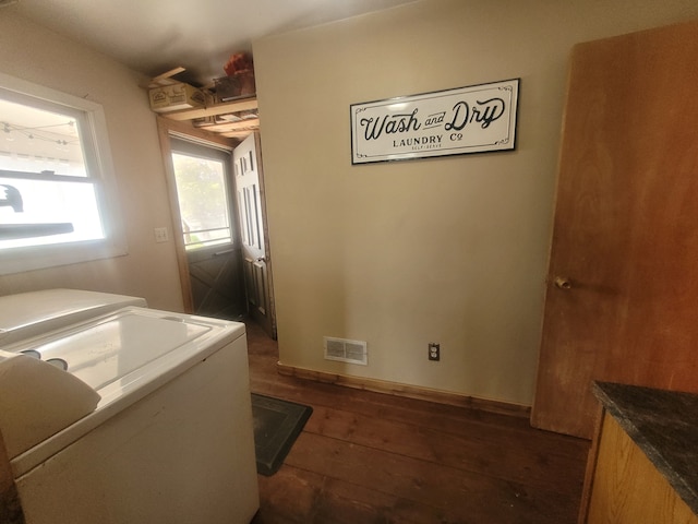 laundry area with dark wood-type flooring and independent washer and dryer