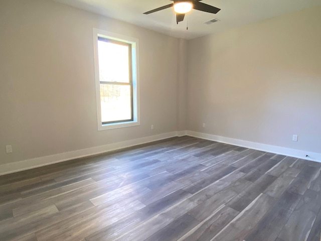 empty room with ceiling fan and dark wood-type flooring