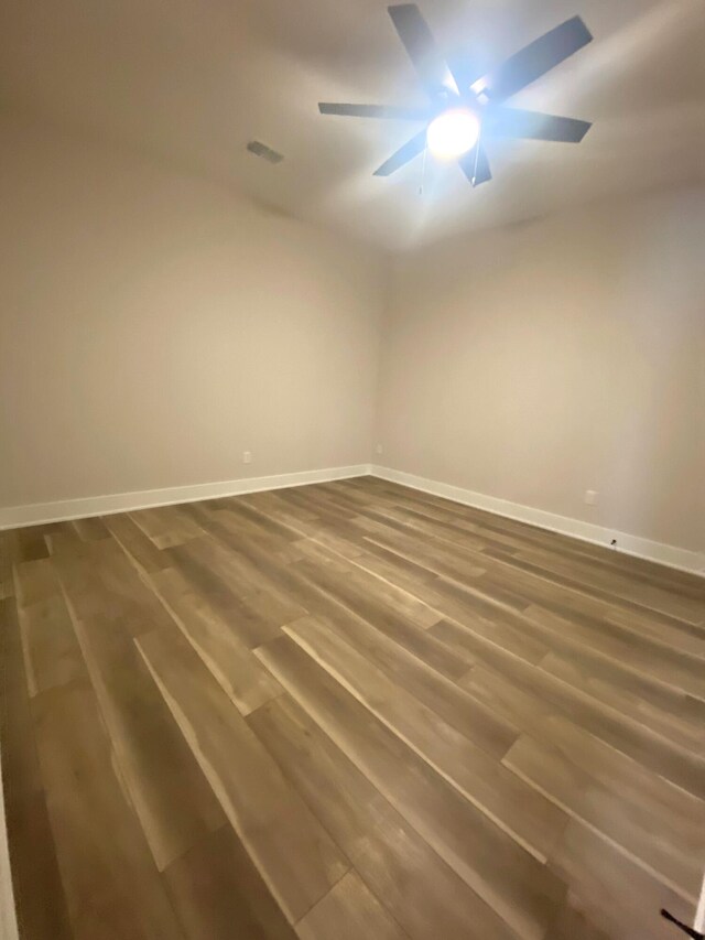 7480/7482 Head Rd, Delton, MI 49046 - empty room featuring baseboards, dark wood finished floors, and ceiling fan