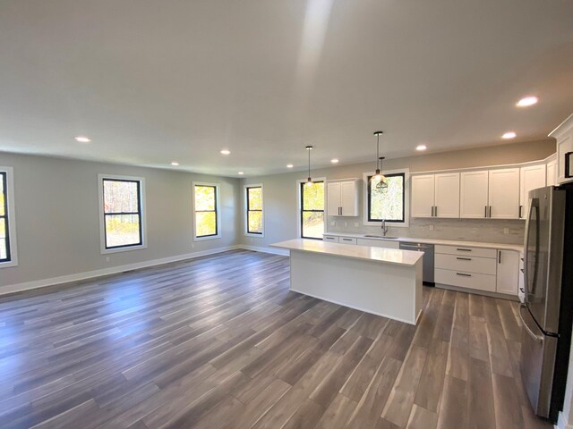 7480/7482 Head Rd, Delton, MI 49046 - kitchen with appliances with stainless steel finishes, a sink, recessed lighting, open floor plan, and light countertops