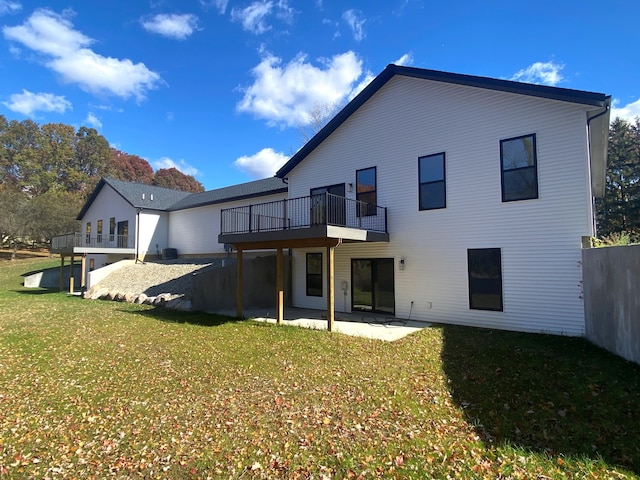 rear view of property with a lawn and a patio area