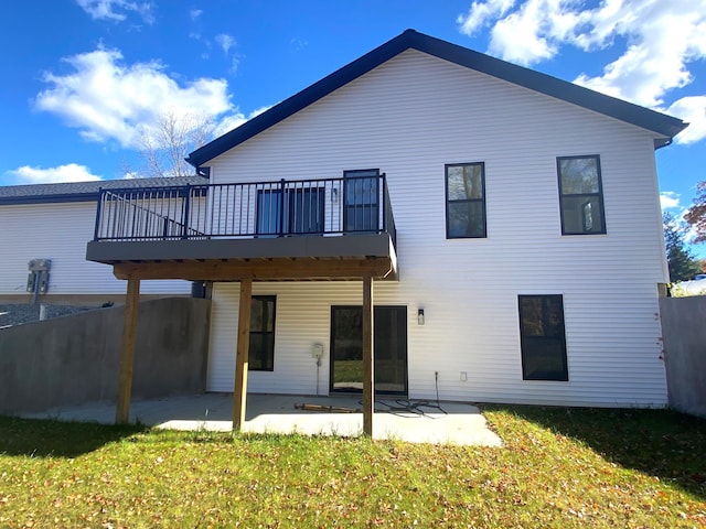 rear view of property with a yard, a patio area, and a wooden deck