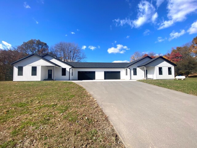 7480/7482 Head Rd, Delton, MI 49046 - modern farmhouse featuring a garage, driveway, and a front lawn