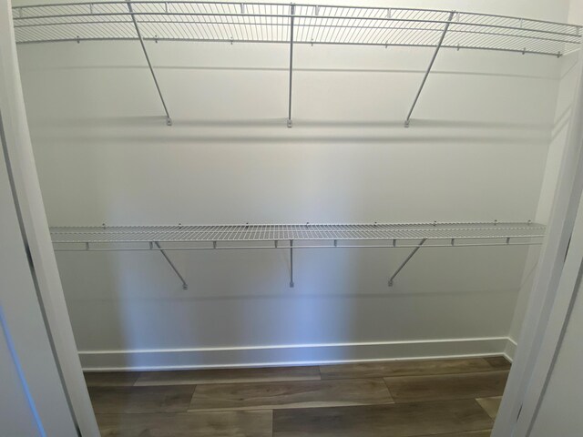 7480/7482 Head Rd, Delton, MI 49046 - spacious closet featuring dark wood-type flooring