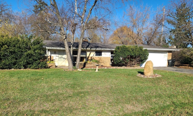 ranch-style home with a garage and a front lawn