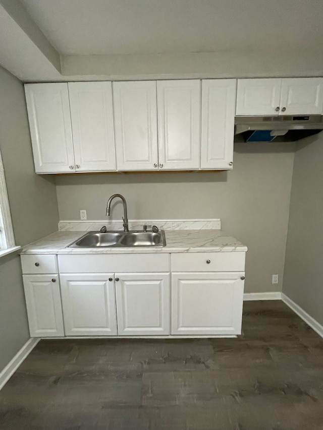 kitchen featuring white cabinets, dark hardwood / wood-style floors, and sink