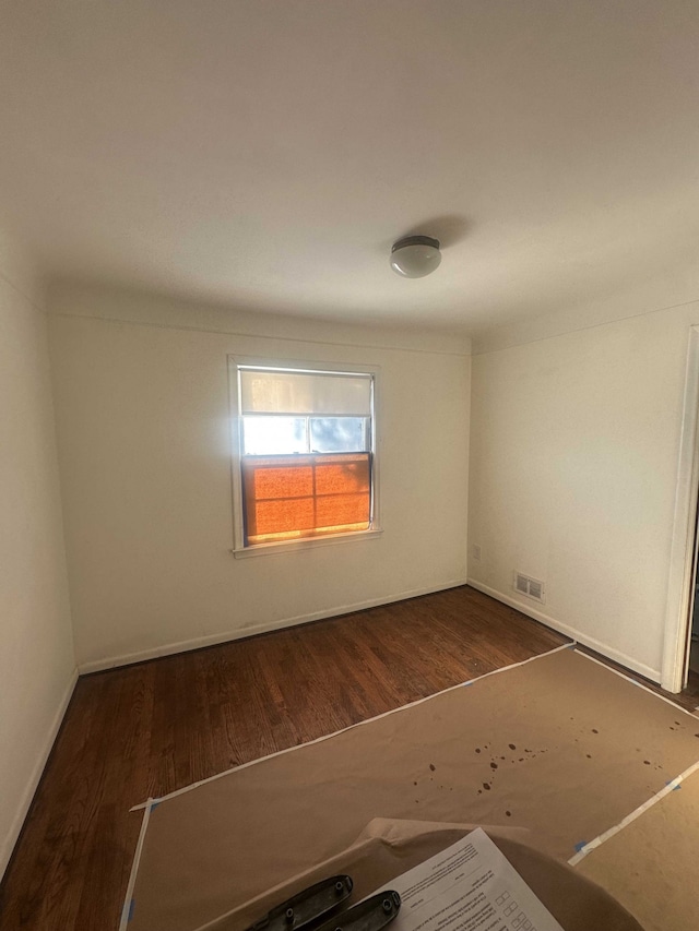 empty room featuring dark hardwood / wood-style flooring