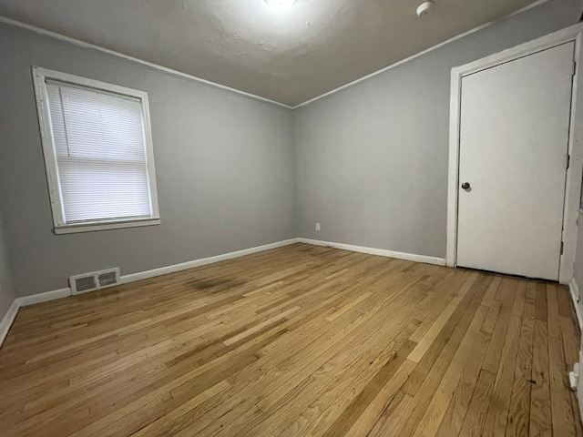 interior space with light hardwood / wood-style floors and ornamental molding