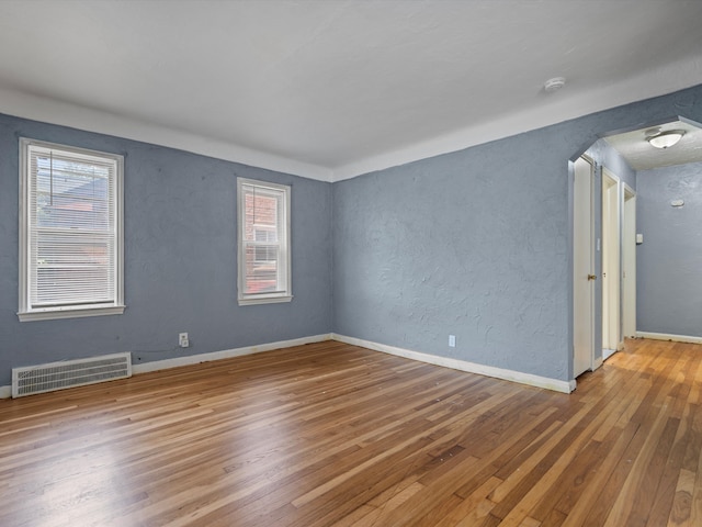 unfurnished room featuring hardwood / wood-style floors