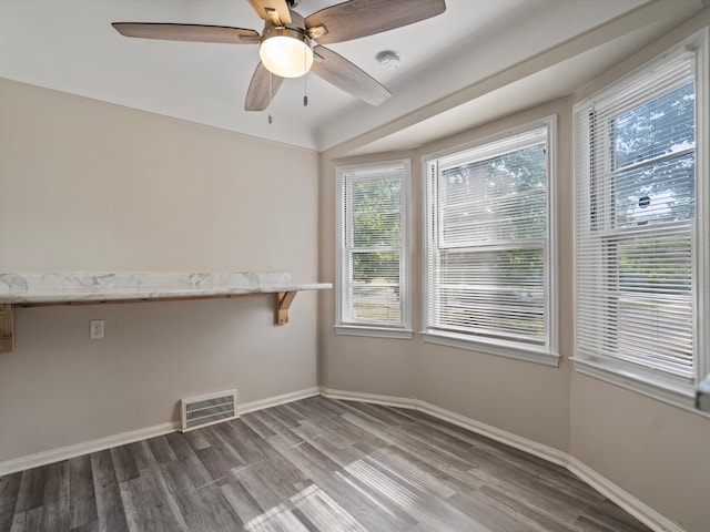 unfurnished room featuring ceiling fan and hardwood / wood-style flooring