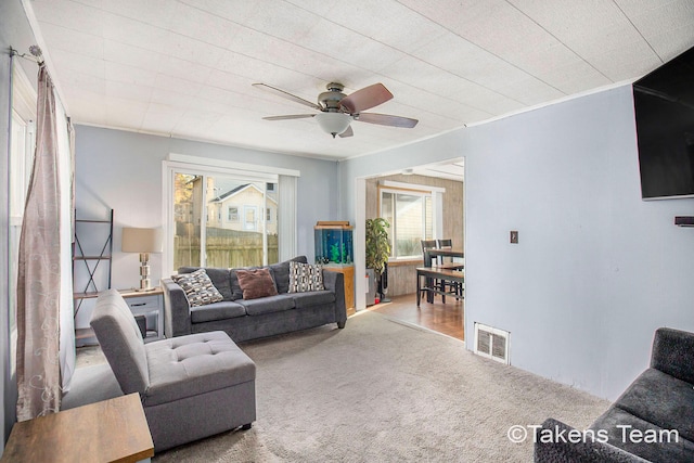 carpeted living room featuring ceiling fan