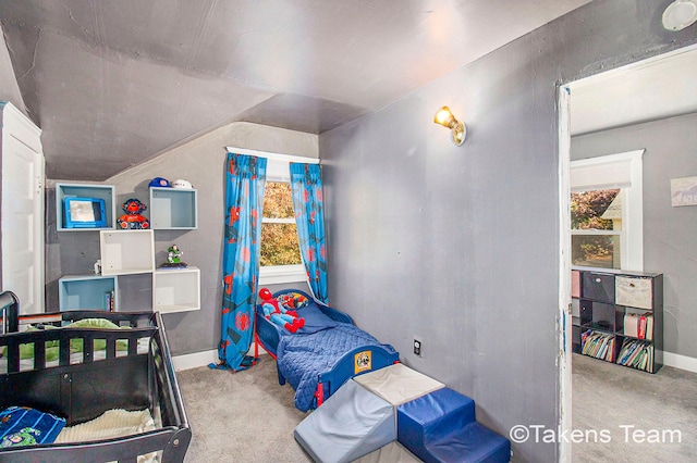 bedroom featuring light carpet and vaulted ceiling