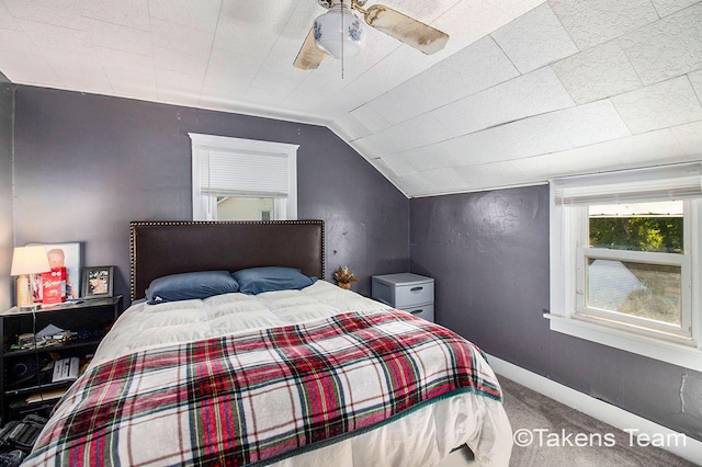 carpeted bedroom with vaulted ceiling and ceiling fan