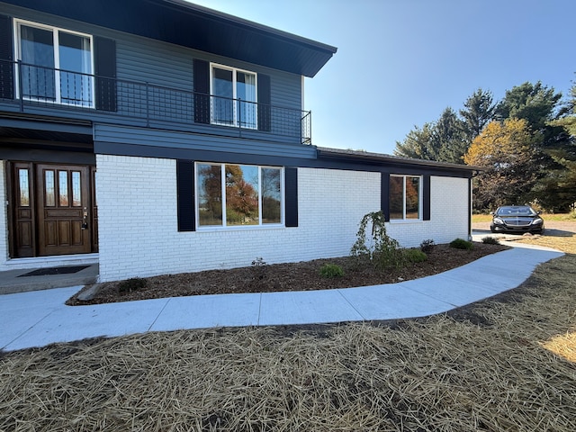 view of side of property with a balcony