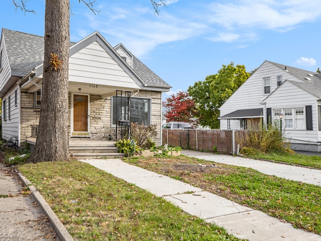 bungalow-style house with a front lawn and a porch