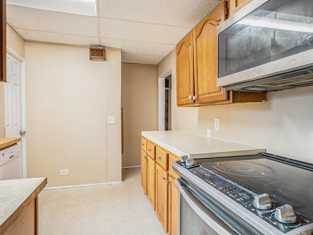 kitchen with a paneled ceiling and appliances with stainless steel finishes