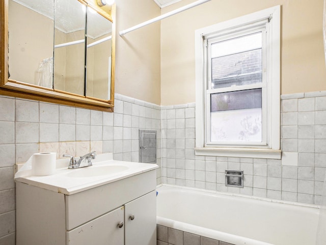 bathroom with a washtub and vanity