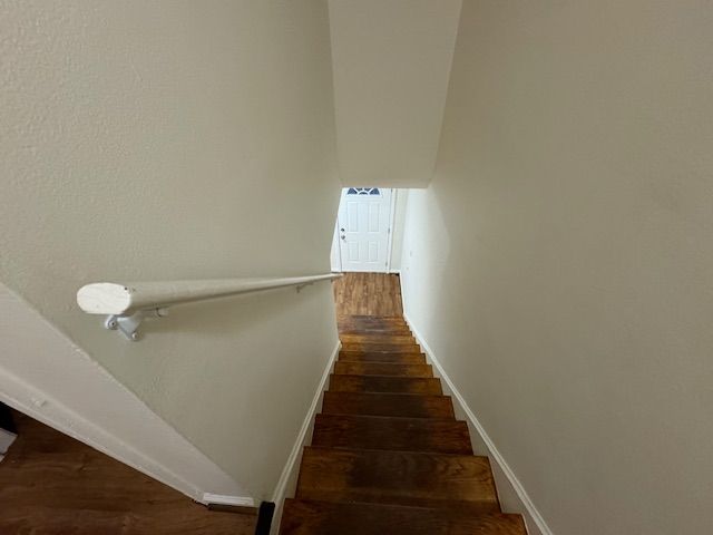 stairway with hardwood / wood-style flooring