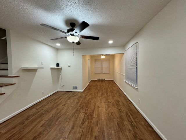 washroom featuring hardwood / wood-style flooring, ceiling fan, and a textured ceiling