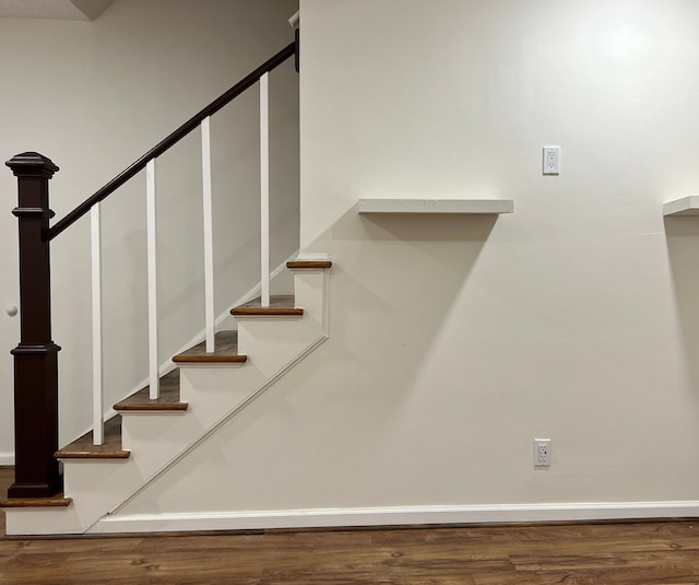 stairs with hardwood / wood-style flooring