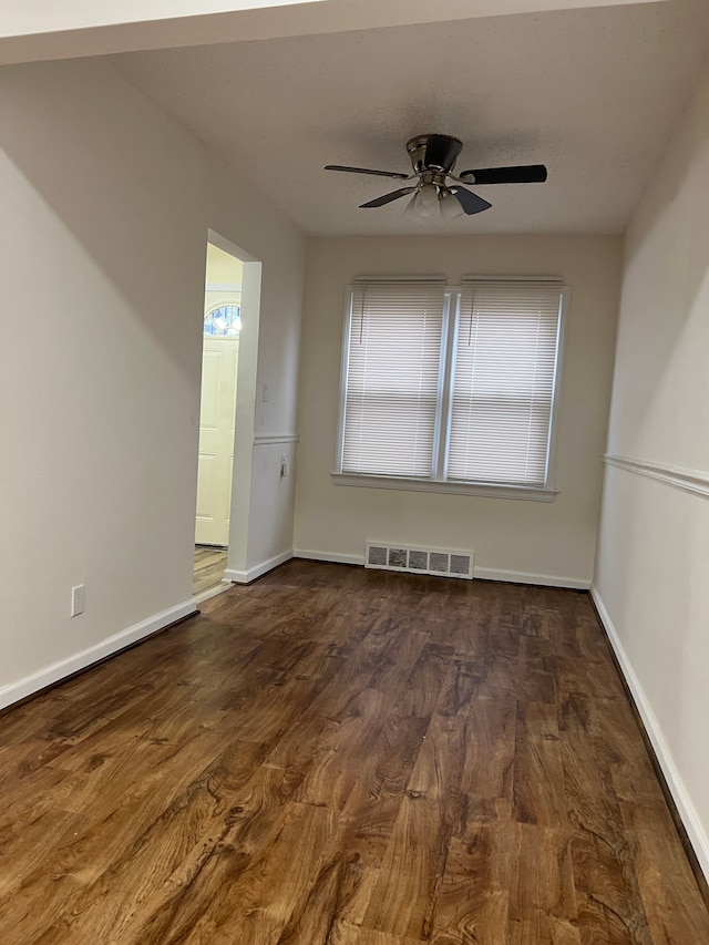 unfurnished room featuring dark hardwood / wood-style flooring and ceiling fan