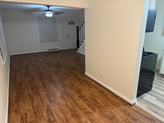 interior space with wood-type flooring and ceiling fan