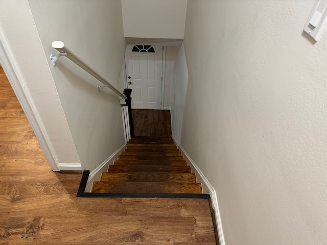 stairs featuring hardwood / wood-style flooring