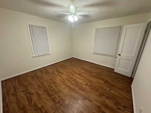 unfurnished bedroom with ceiling fan, a textured ceiling, and dark hardwood / wood-style flooring