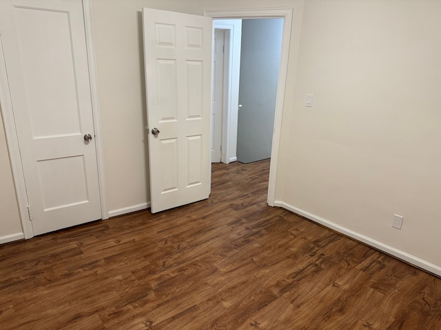 unfurnished bedroom featuring dark hardwood / wood-style floors