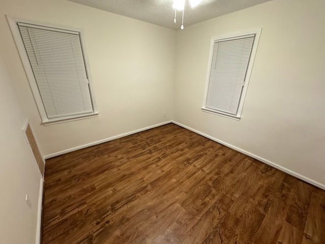 unfurnished bedroom featuring dark hardwood / wood-style flooring and a textured ceiling