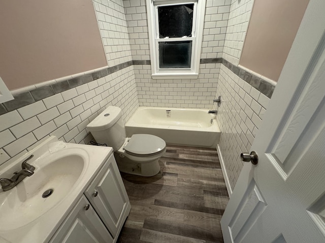 bathroom with hardwood / wood-style floors, vanity, tile walls, and toilet