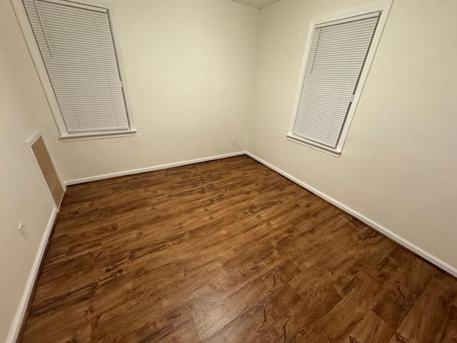 unfurnished bedroom with dark wood-type flooring