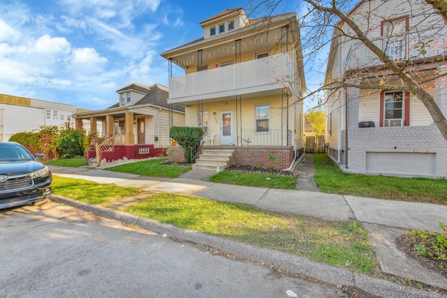 view of front of home featuring covered porch, a garage, and a balcony