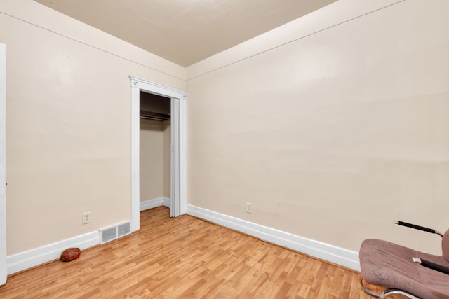 unfurnished bedroom with a closet and light hardwood / wood-style floors