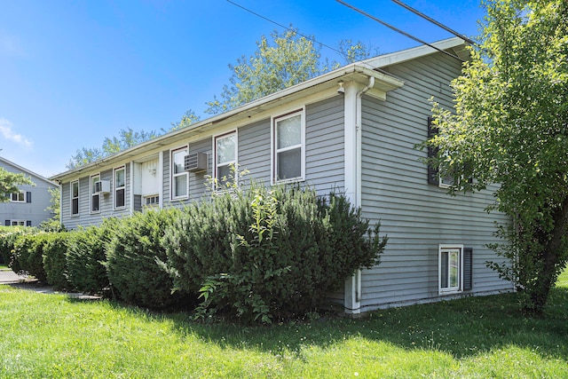 view of property exterior with a lawn