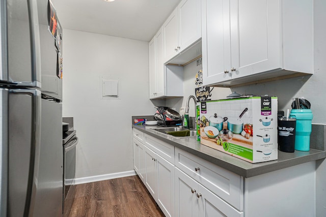 kitchen with white cabinets, dark hardwood / wood-style flooring, sink, and stainless steel appliances