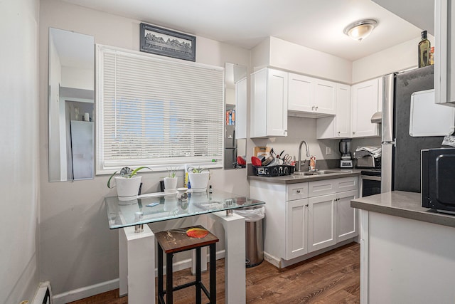 kitchen featuring white cabinets, ventilation hood, sink, dark hardwood / wood-style floors, and a kitchen bar