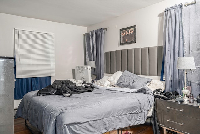 bedroom with dark hardwood / wood-style floors