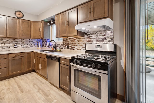 kitchen with decorative backsplash, stainless steel appliances, a healthy amount of sunlight, and sink