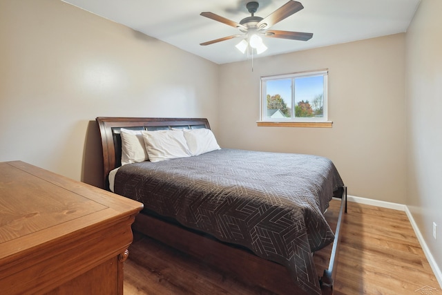 bedroom featuring hardwood / wood-style flooring and ceiling fan