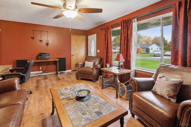 living room featuring ceiling fan and light wood-type flooring