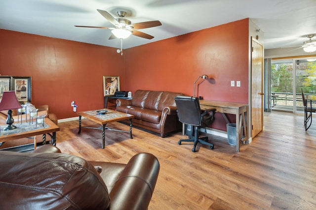 living room with ceiling fan and wood-type flooring