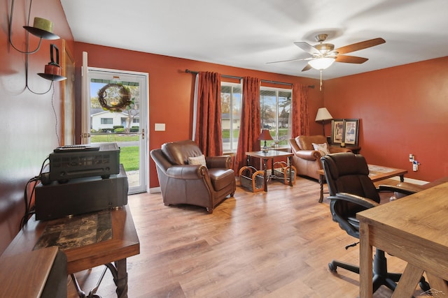 home office with ceiling fan and light hardwood / wood-style flooring