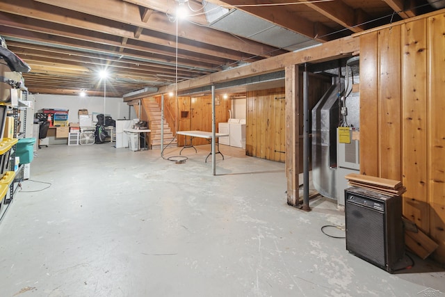 basement featuring washer and dryer and wood walls