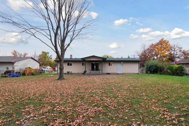 rear view of property with a yard