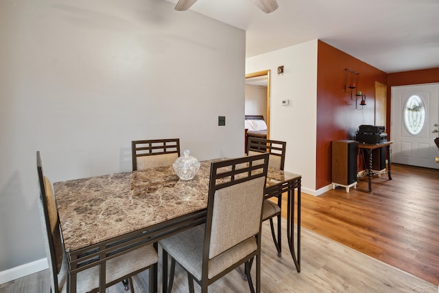 dining space with ceiling fan and hardwood / wood-style floors