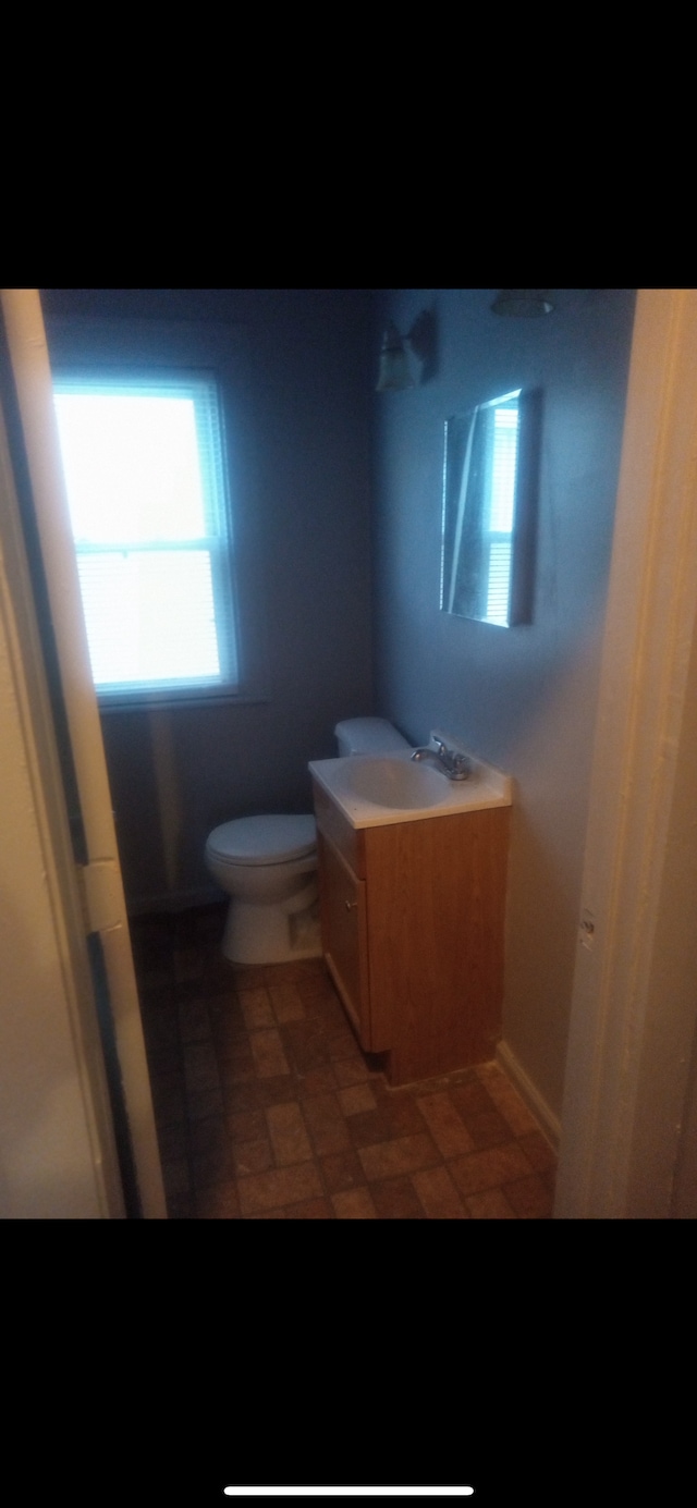 bathroom with tile patterned floors, vanity, and toilet